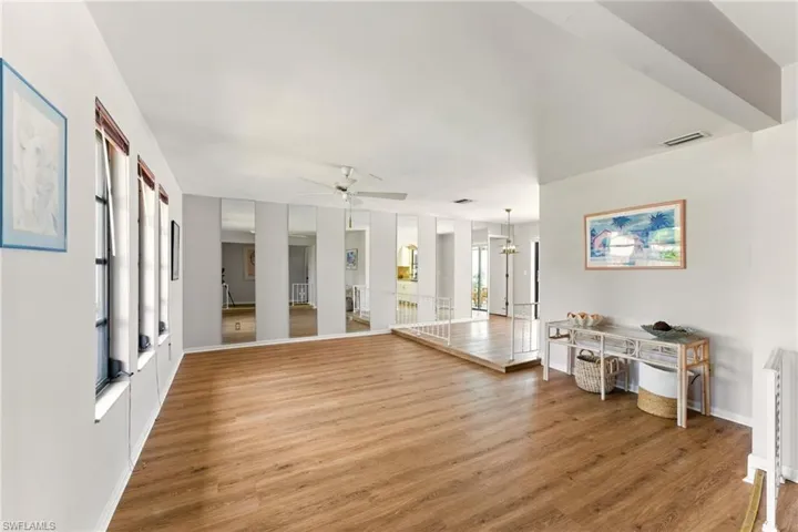 Entryway featuring luxury vinyl flooring and a stepdown into living area