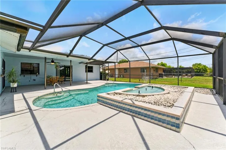 Swimming pool featuring a patio, ceiling fan, water fountain,  screened lanai.