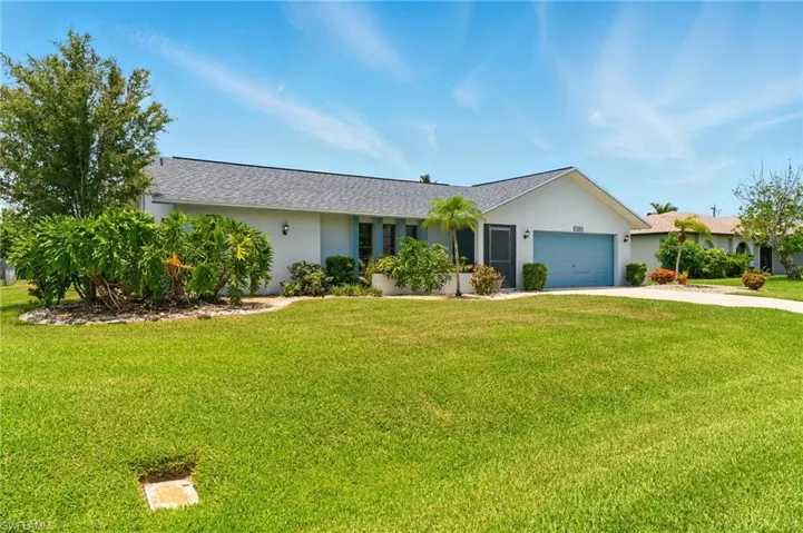 Single story home featuring concrete driveway, a 2 car garage, stucco siding, and lush landscaping, ROOF 2020