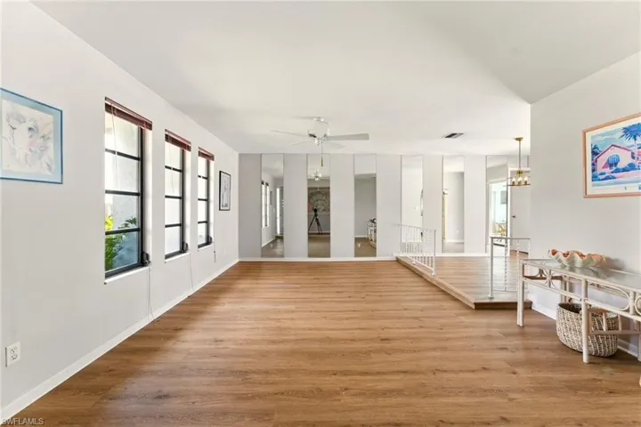 Entryway featuring luxury vinyl flooring and a stepdown into living area