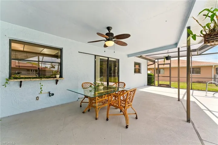 View of patio / terrace featuring ceiling fan and a lanai
