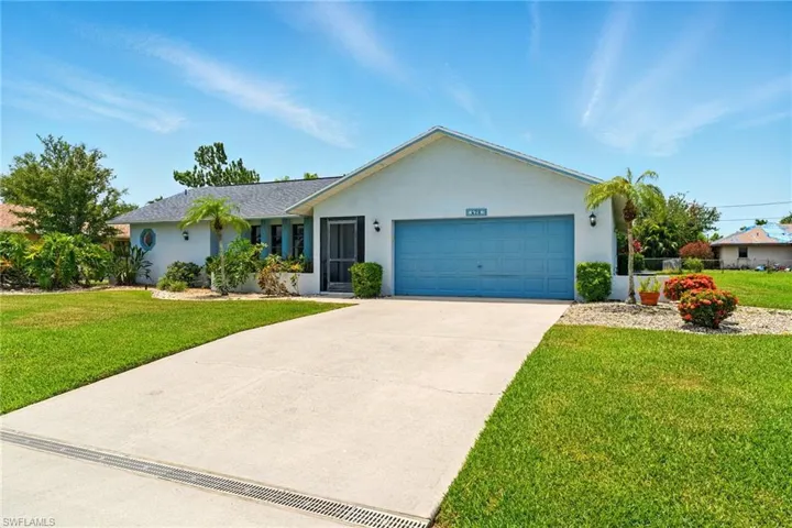 Single story home featuring concrete driveway, a 2 car garage, stucco siding, and lush landscaping, ROOF 2020