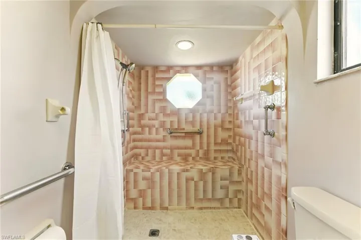 Full bathroom featuring a tile shower and plenty of natural light
