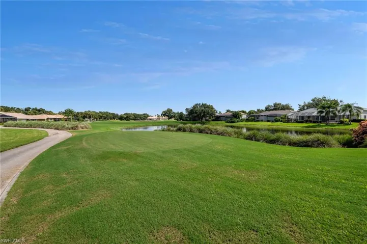 View of property's community featuring a water view and a lawn