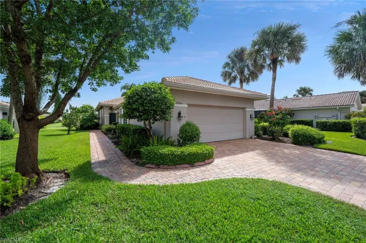 View of front of home with a front lawn and a garage