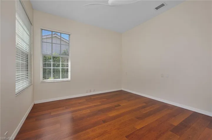 Unfurnished room with dark hardwood / wood-style flooring