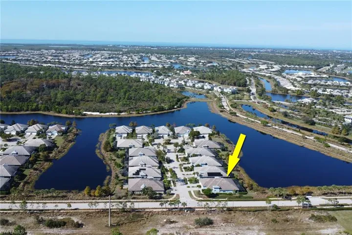 View of property location with a large body of water and nearby suburban area