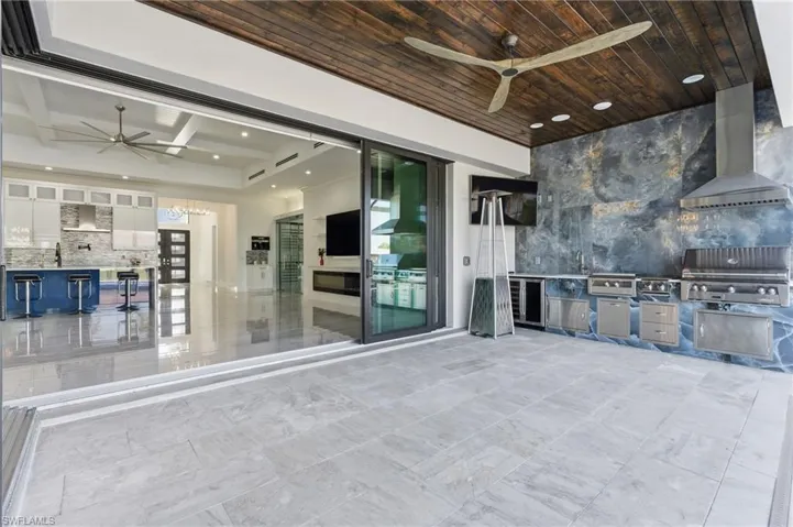 View of patio with ceiling fan and exterior kitchen
