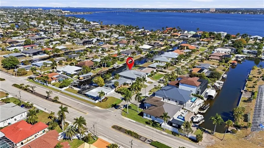 Ariel shot. 5 min. to Open water and 5 min. walk to the BEACH!surrounding area featuring nearby suburban area, a large body of water, and a notable bridge