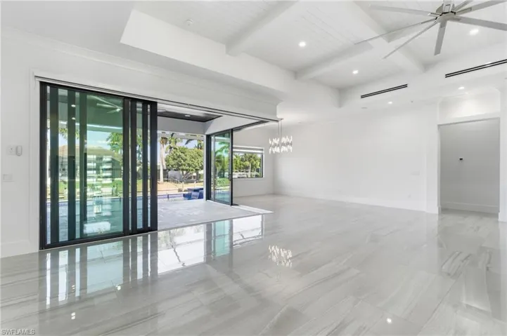 Unfurnished room with recessed lighting, beamed ceiling, a chandelier, ceiling fan, and coffered ceiling