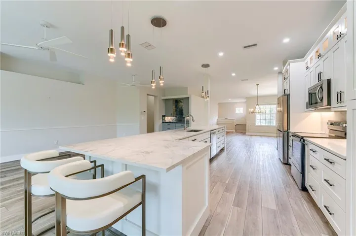 White Shaker Cabinetry with Lighted glass upper cabinetry above