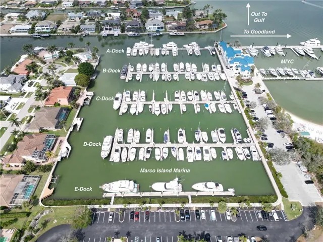 Aerial overview of property's location featuring a nearby body of water and numerous boat docks