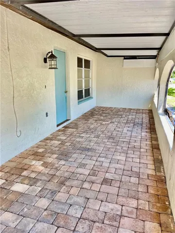Detailed paved covered front entrance.