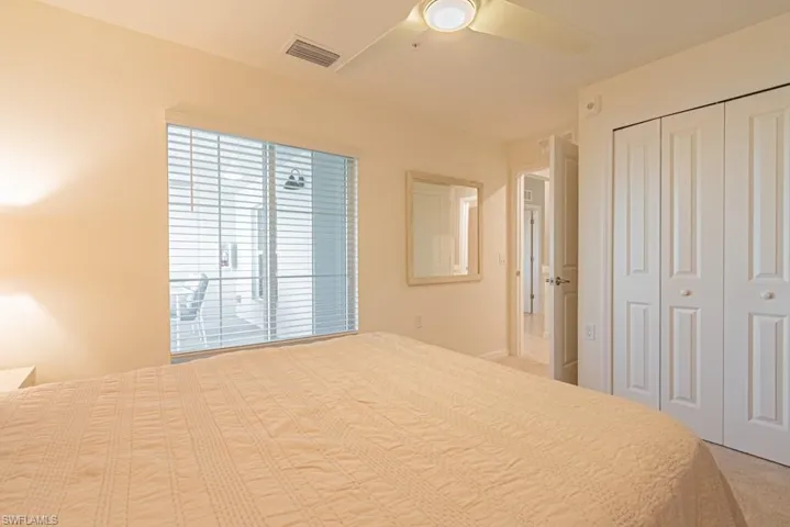 Bedroom featuring a closet, a ceiling fan, and carpet floors