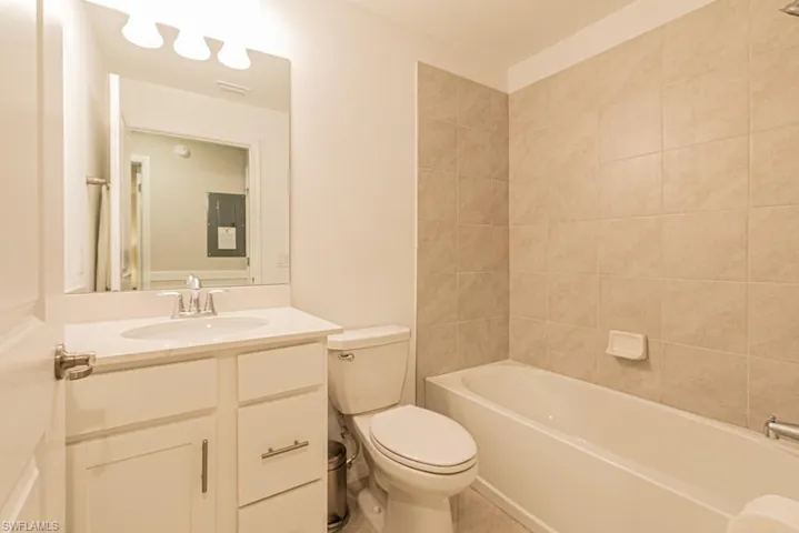 Bathroom with vanity, tile patterned floors, and tub / shower combination