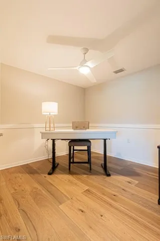 Unfurnished office featuring light wood-style flooring and ceiling fan