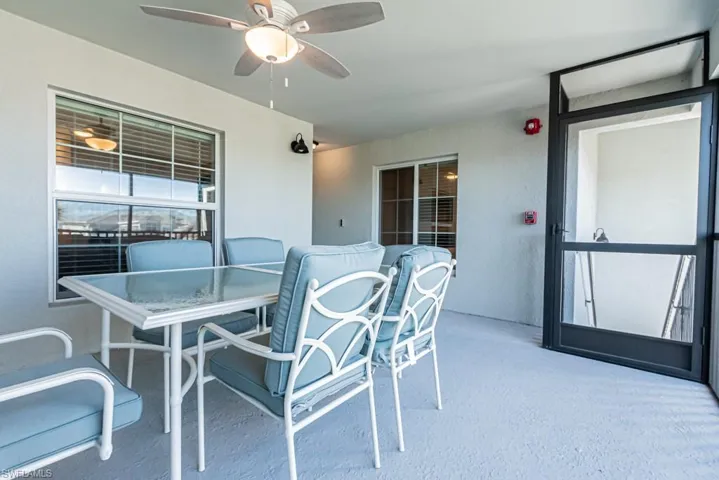 View of patio with ceiling fan and outdoor dining area