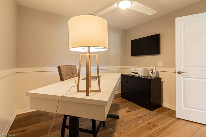 Office space with wood finished floors and ceiling fan