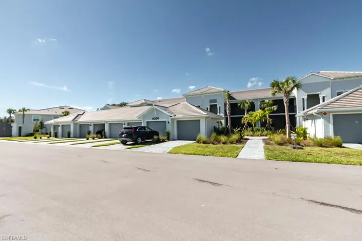View of front of home featuring a residential view, driveway, and a garage