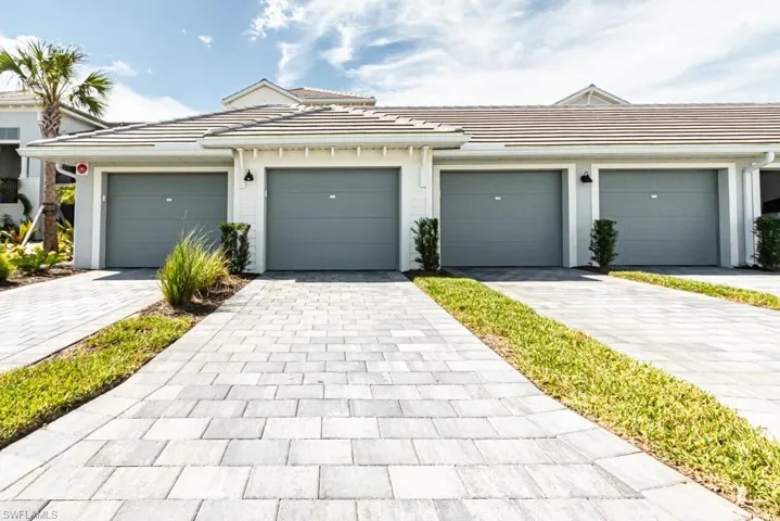 View of front of home featuring a tiled roof and stucco siding