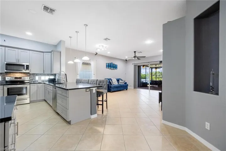 Kitchen with a breakfast bar, kitchen peninsula and stainless steel appliances