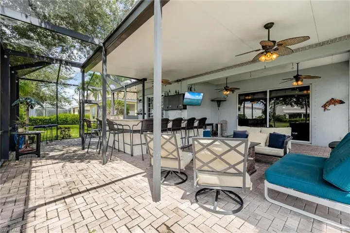 Lanai with a outdoor kitchen/ bar and an outdoor hangout area