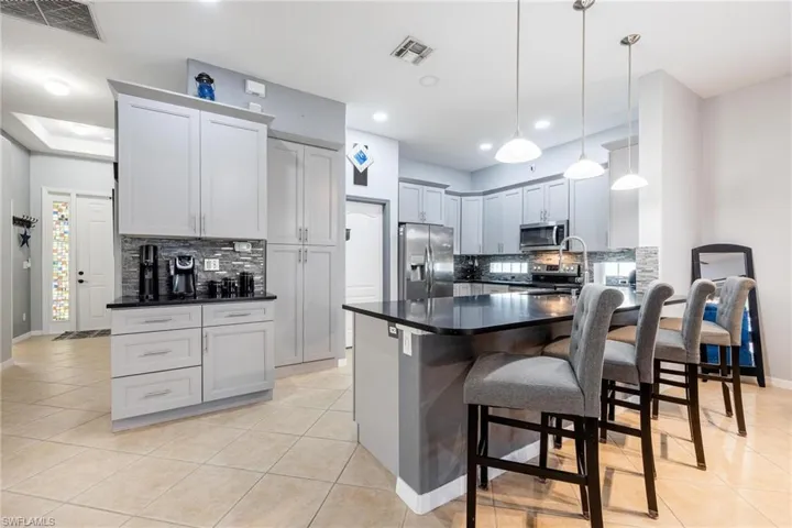 Kitchen featuring tile flooring and a breakfast bar