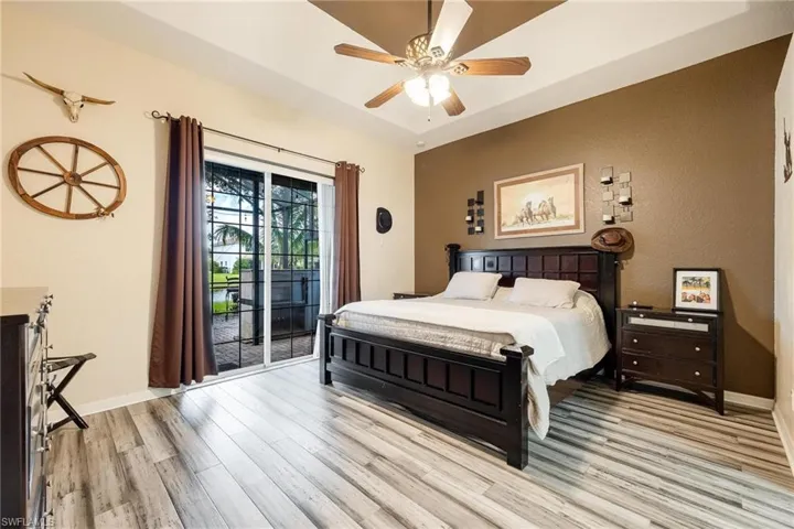 Master Bedroom featuring access to outside, ceiling fan, and light hardwood / wood-style floors
