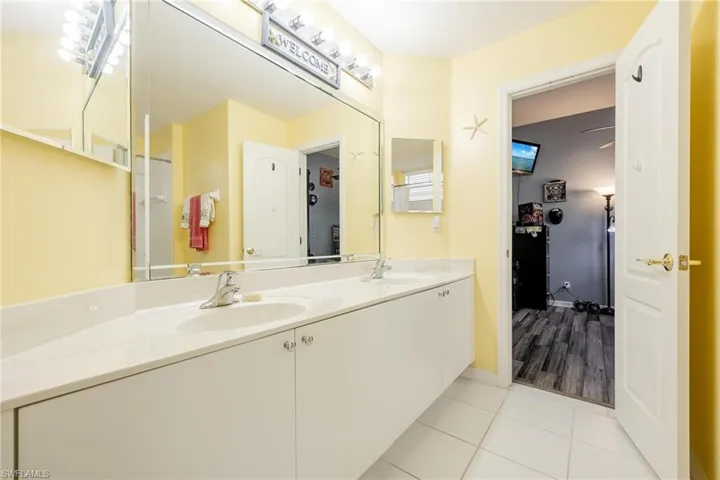 Bathroom featuring dual vanity and tile flooring