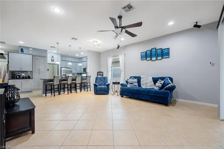 Tiled living room featuring ceiling fan