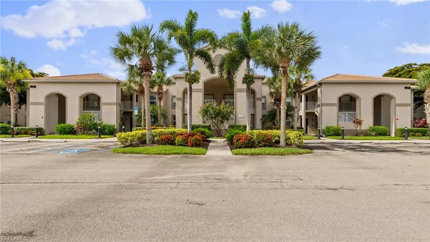 View of property featuring uncovered parking