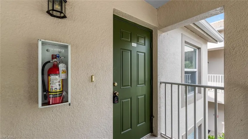 Entrance to property with stucco siding