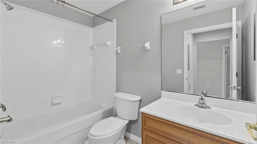 Full bathroom with vanity and washtub / shower combination