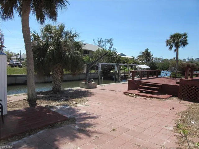 View of patio with a wooden deck