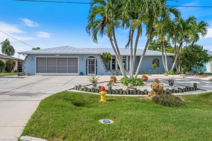 Single story home featuring driveway, an attached garage, stucco siding, and a front yard