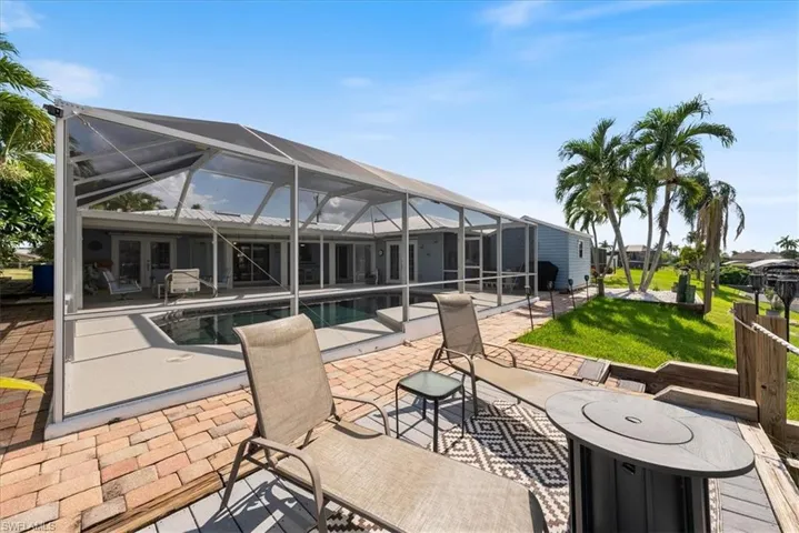 View of patio with an outdoor pool, a lanai, and french doors