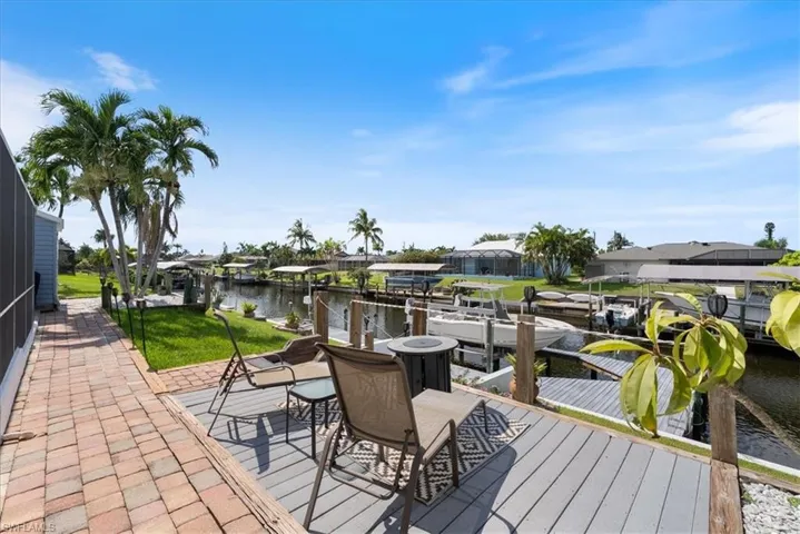 Deck featuring a boat dock, a water view, and a residential view