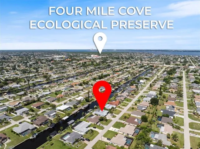 Aerial view of property's location with nearby suburban area