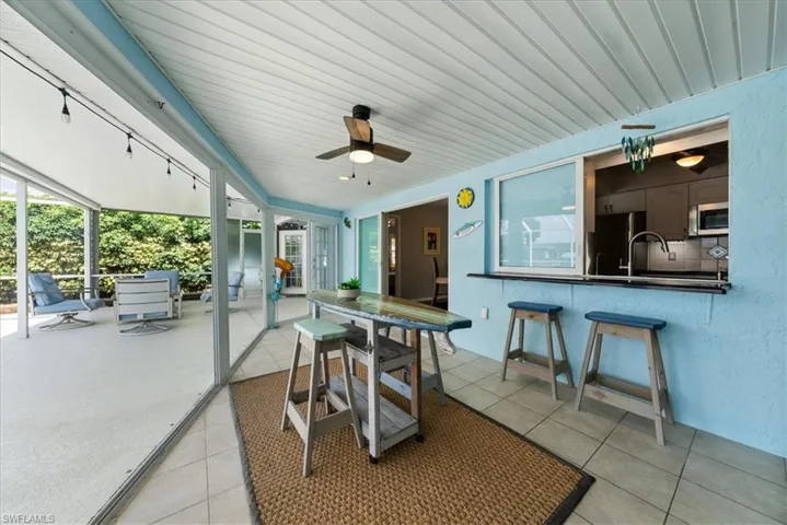 Sunroom featuring a ceiling fan