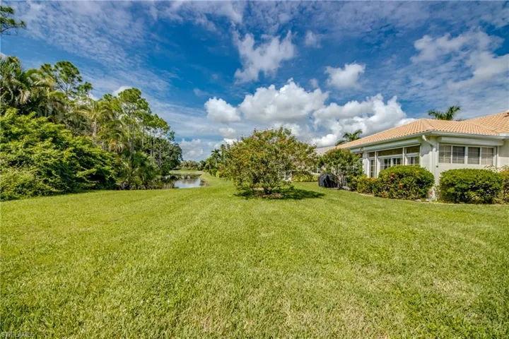 Expansive green lawn with a mature tree