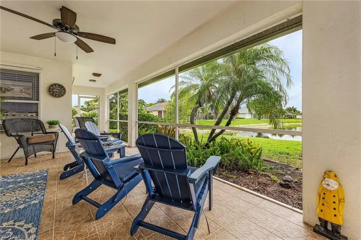 Sunroom with a water view and ceiling fan