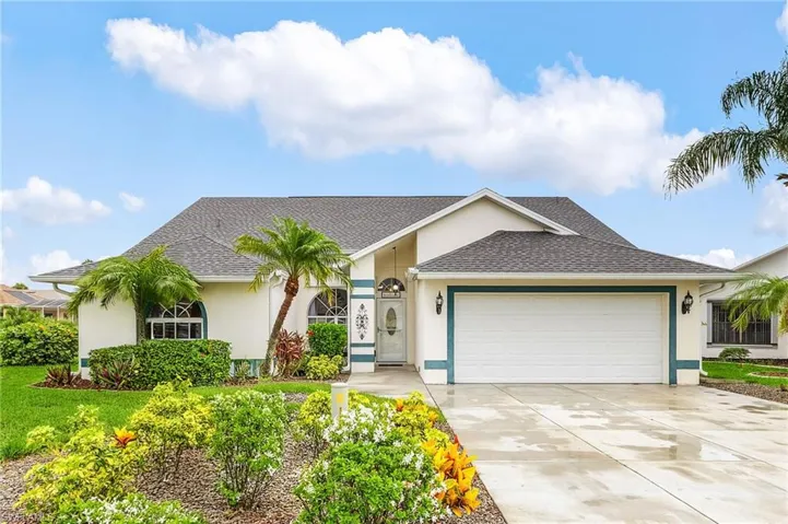 Ranch-style home featuring stucco siding, a garage, driveway, and roof with shingles