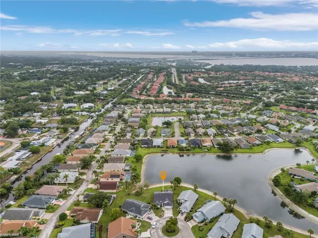 View of property location featuring a nearby body of water and nearby suburban area