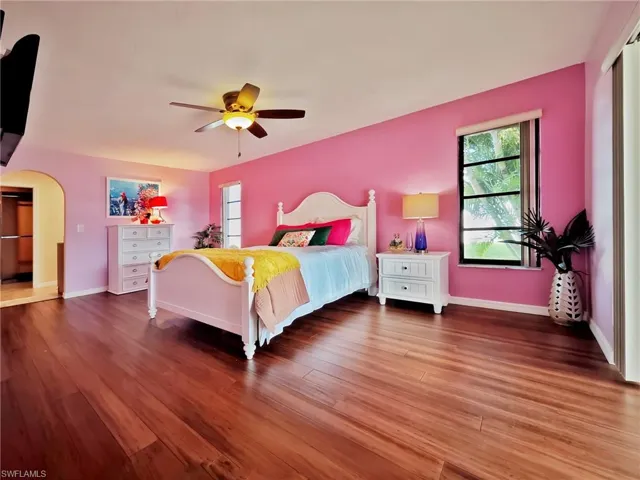 Bedroom featuring ceiling fan and wood-type flooring