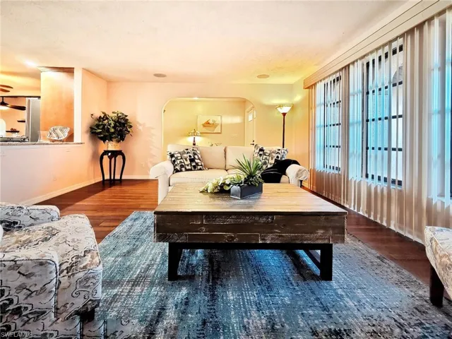 Living room with dark wood-type flooring