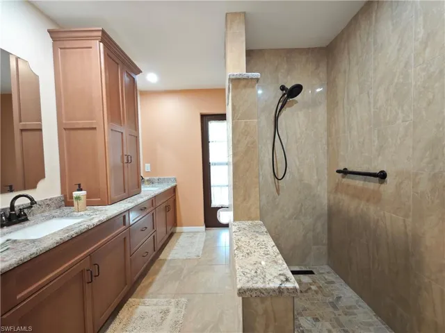 Bathroom with a tile shower and vanity