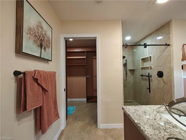 Bathroom with vanity and a shower with shower door