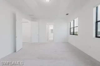 Unfurnished room with light carpet