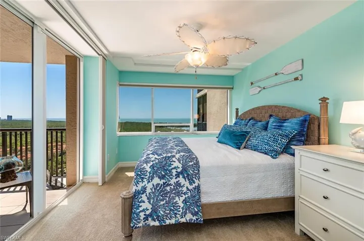 Bedroom with access to exterior, carpet, and ceiling fan