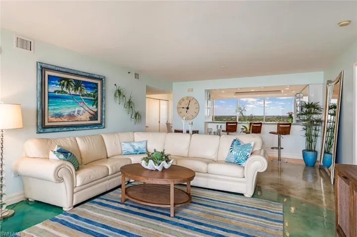 Living area featuring finished concrete flooring and baseboards